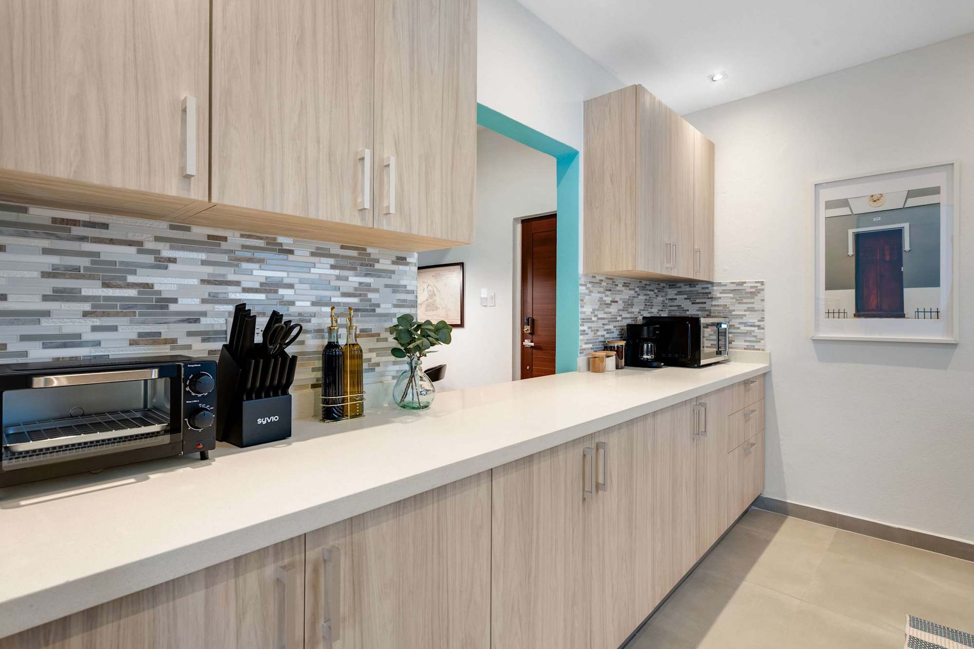 Full kitchen with long counter and coffee station