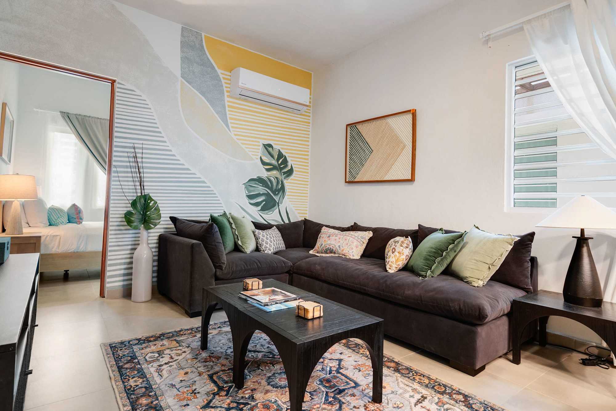 Bright living room with sectional and smart TV
