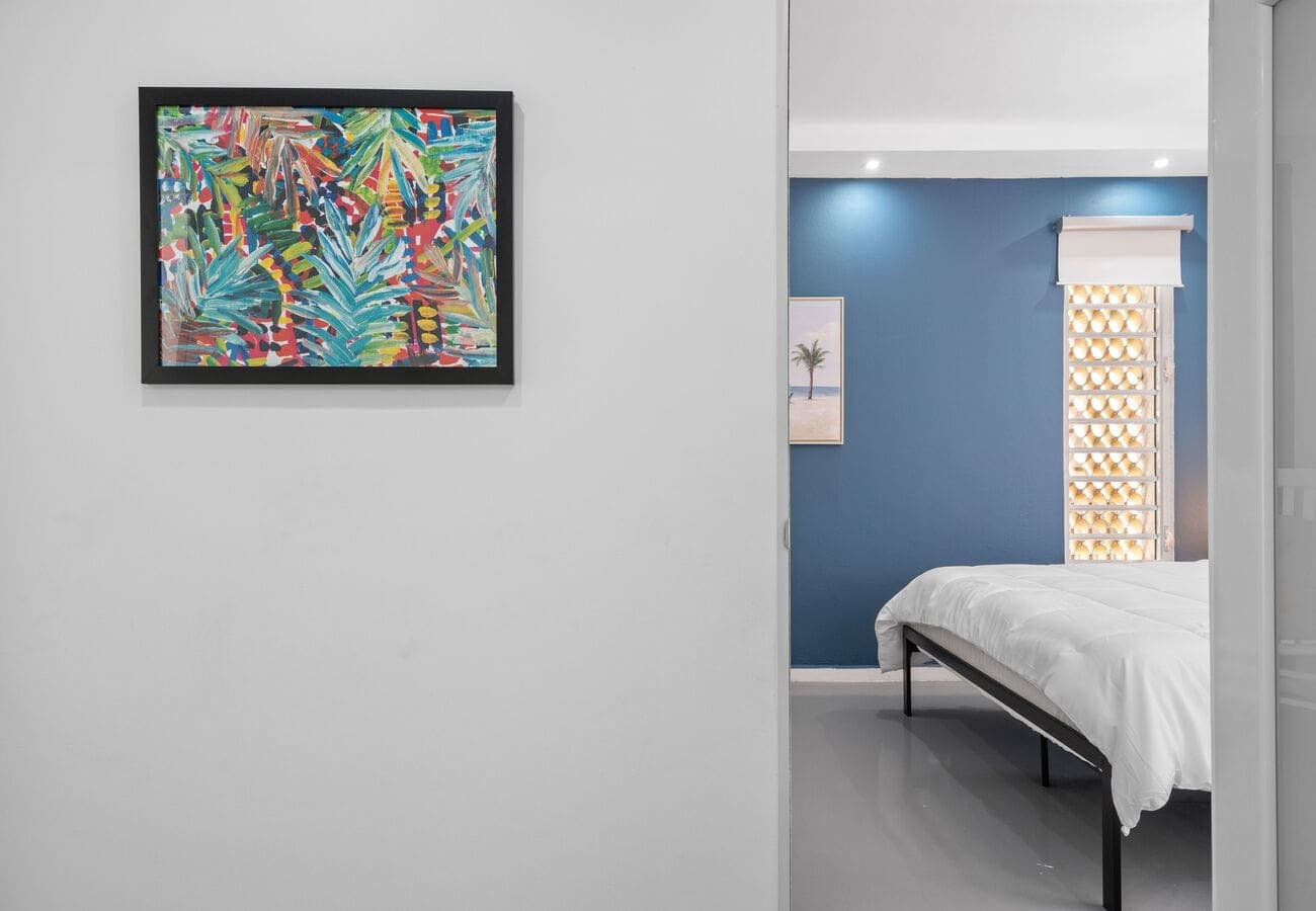 Tropical art with a view into the bedroom