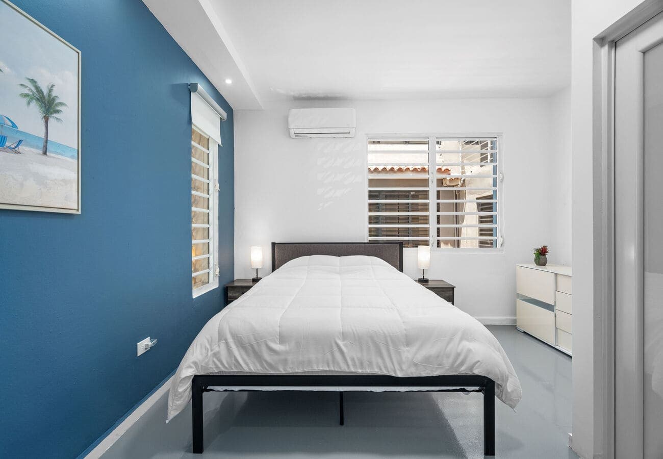 Queen bed with bedside lamps and city light