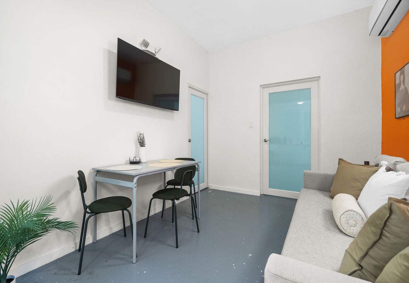 Living area with smart TV, desk & sofa bed