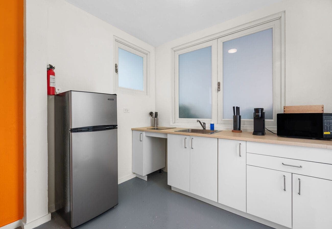 Kitchen with stainless fridge, sink & fire extinguisher