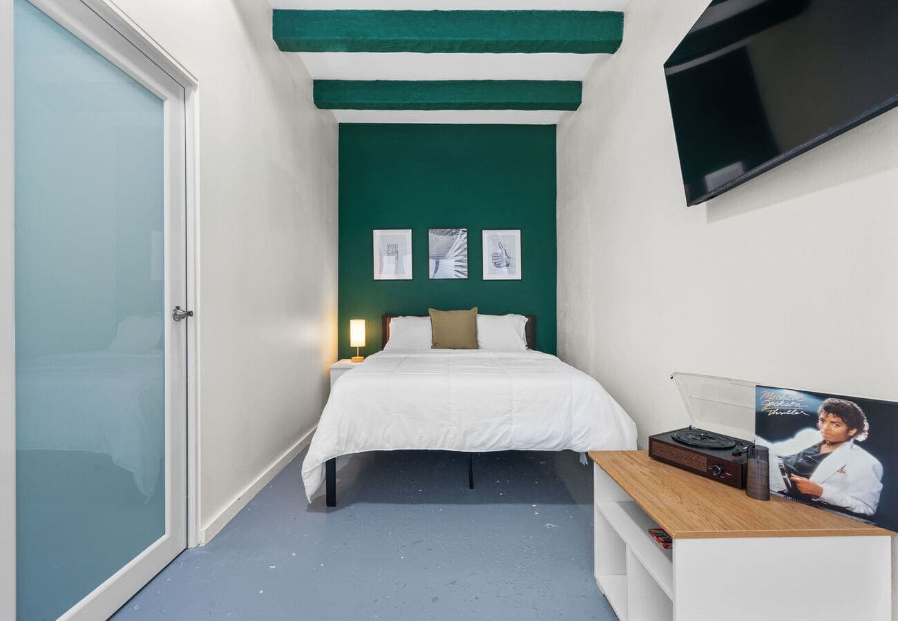 Bedroom with fresh white linens and nightstand lamp