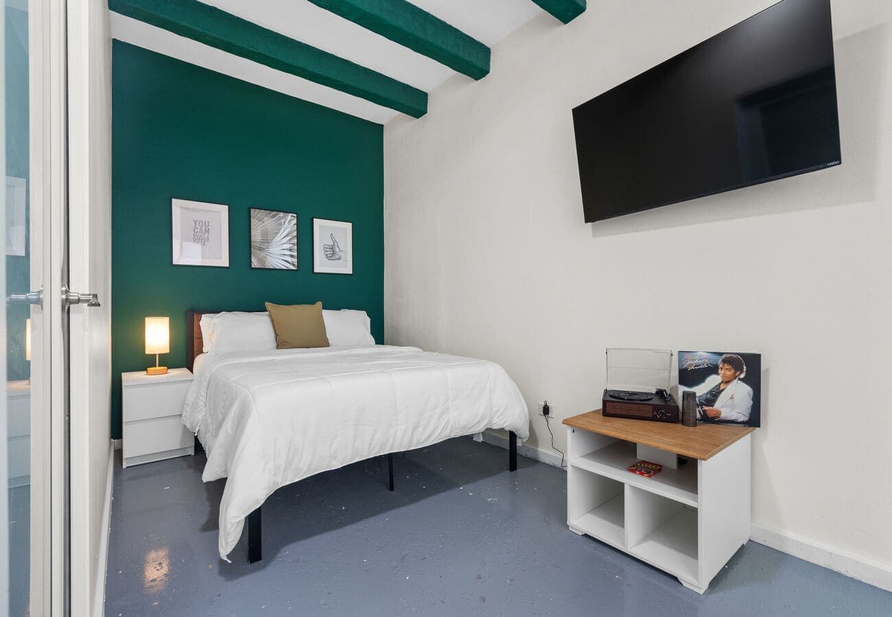 Queen bedroom with A/C, smart TV & record player