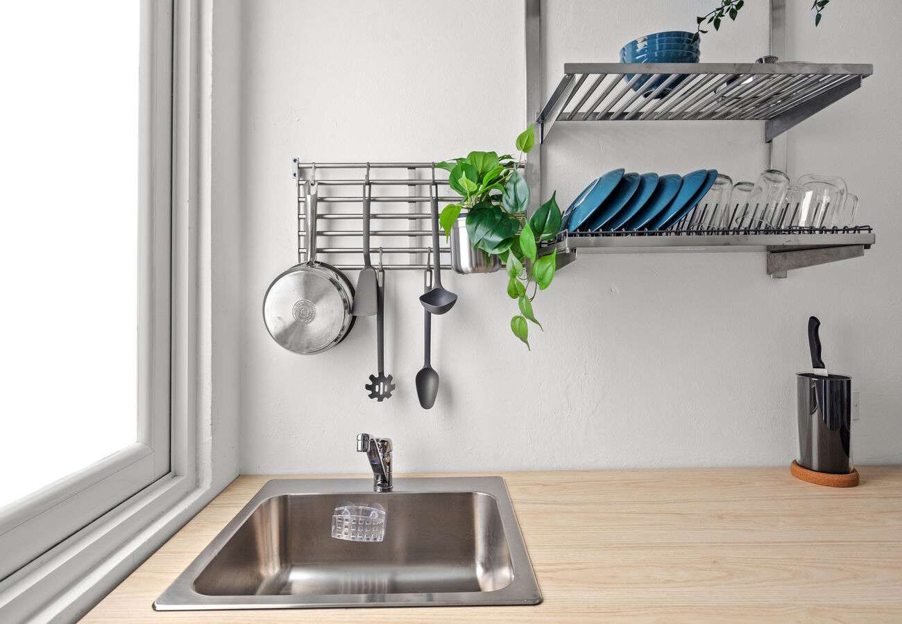 Stainless sink with cookware & utensils