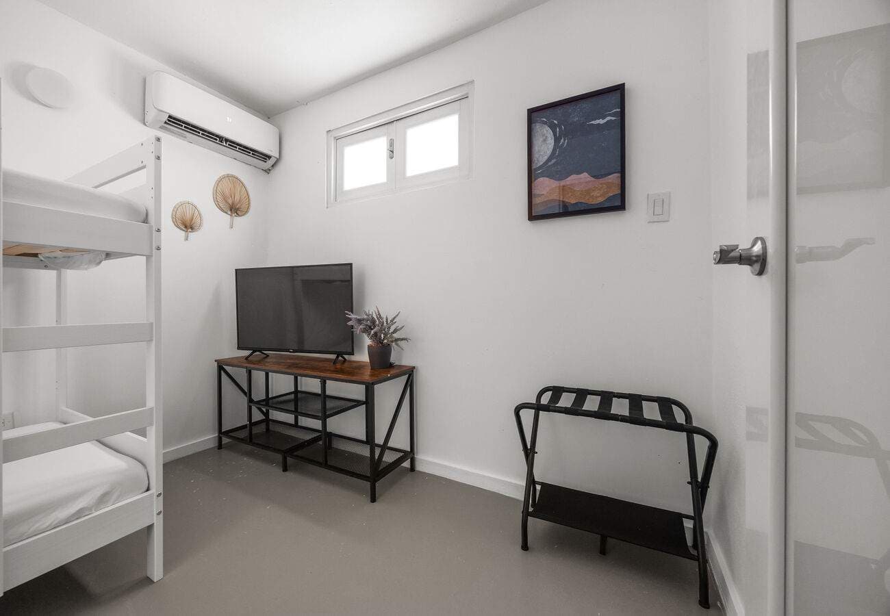 Bunk room with smart TV, A/C & luggage rack