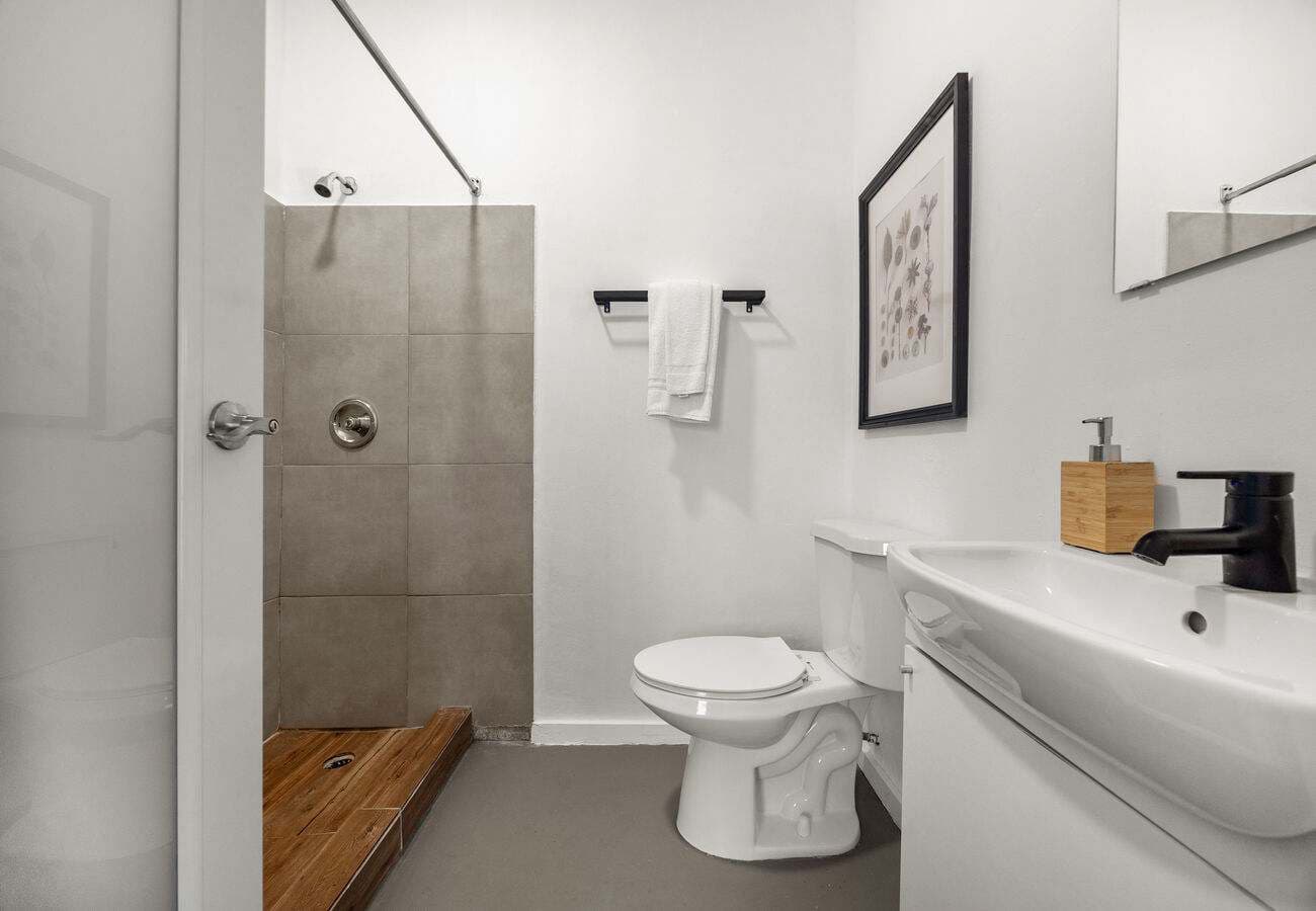 Walk-in shower with wood mat & fresh towels