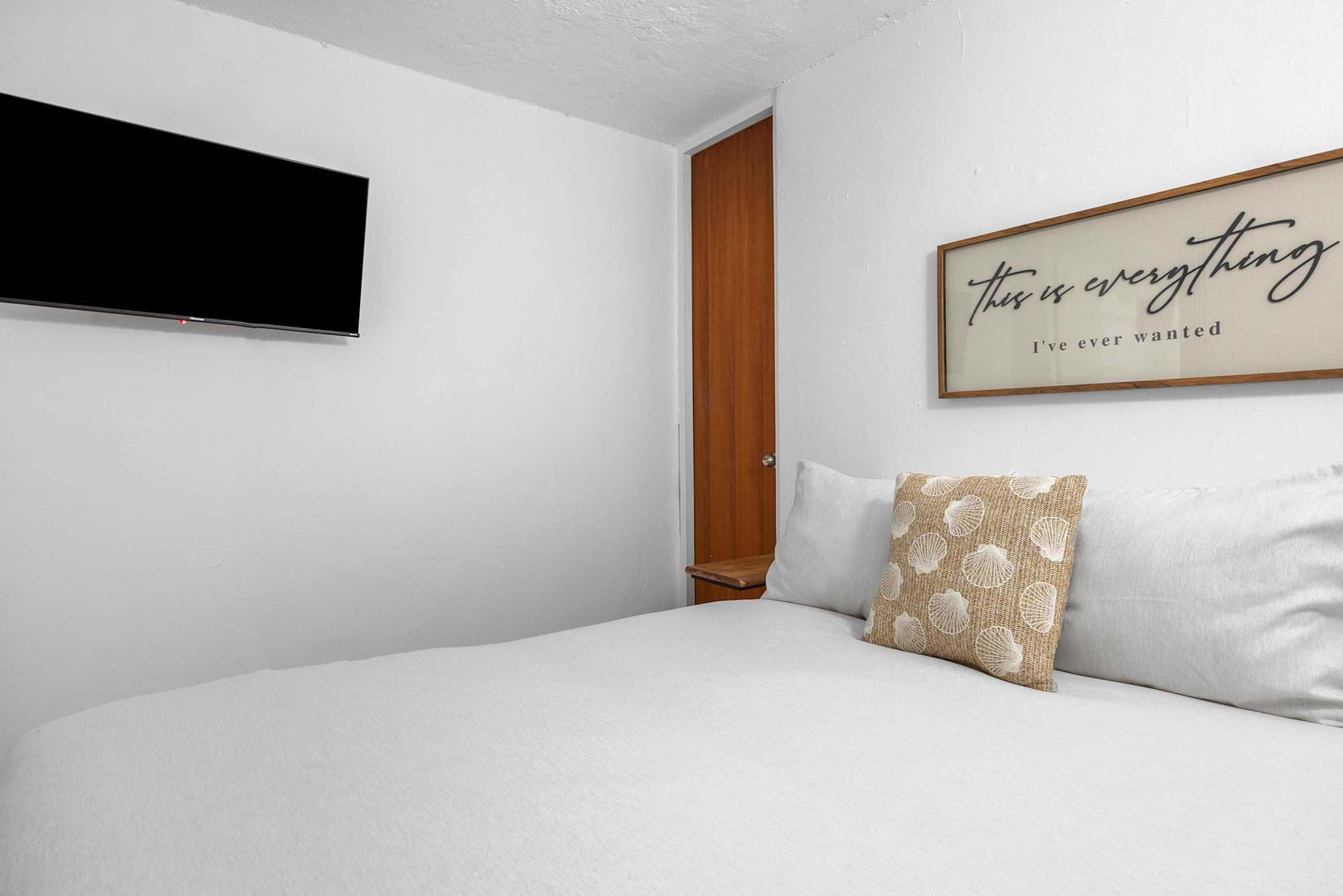 Bedroom with wall-mounted TV