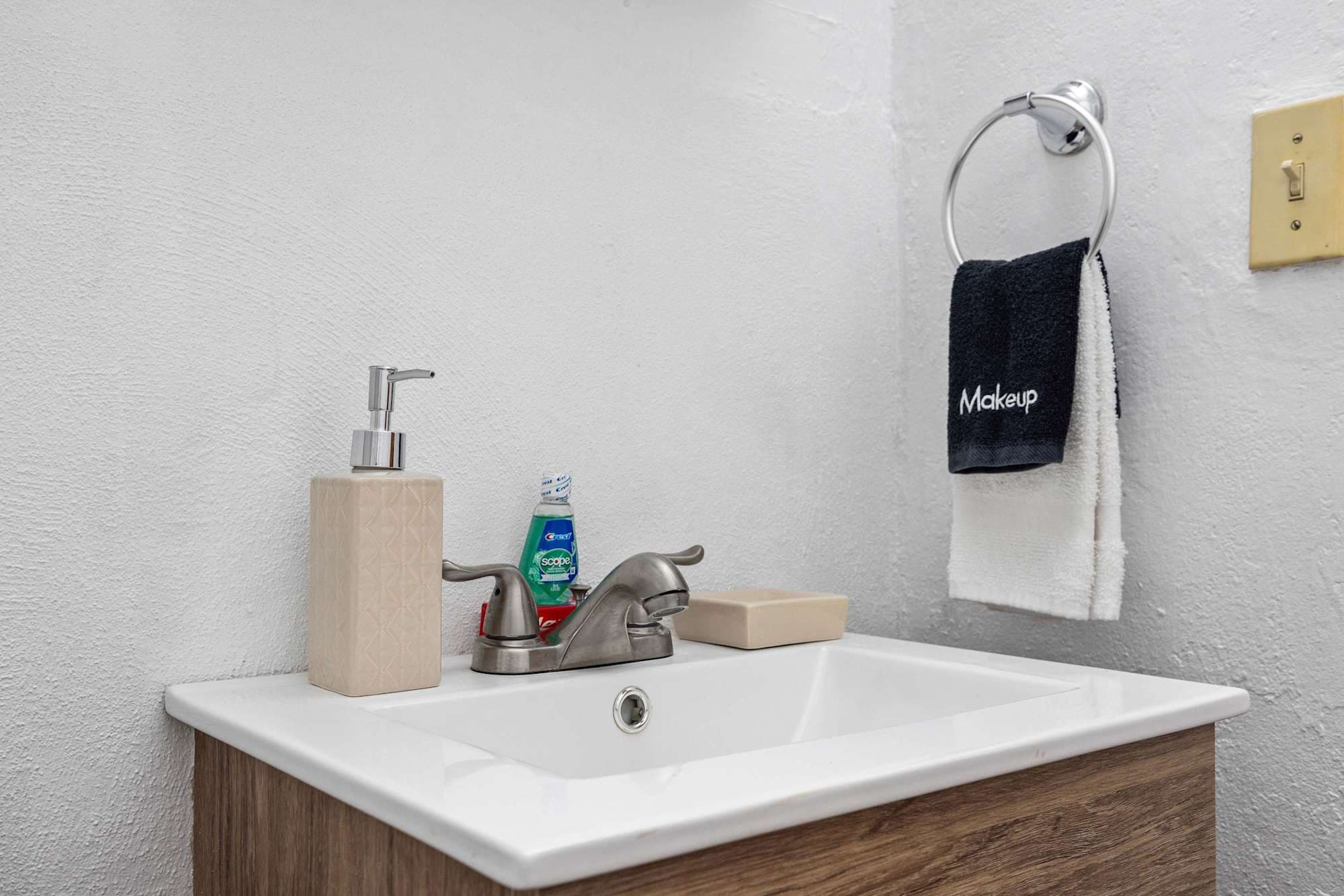Bathroom vanity stocked with toiletries